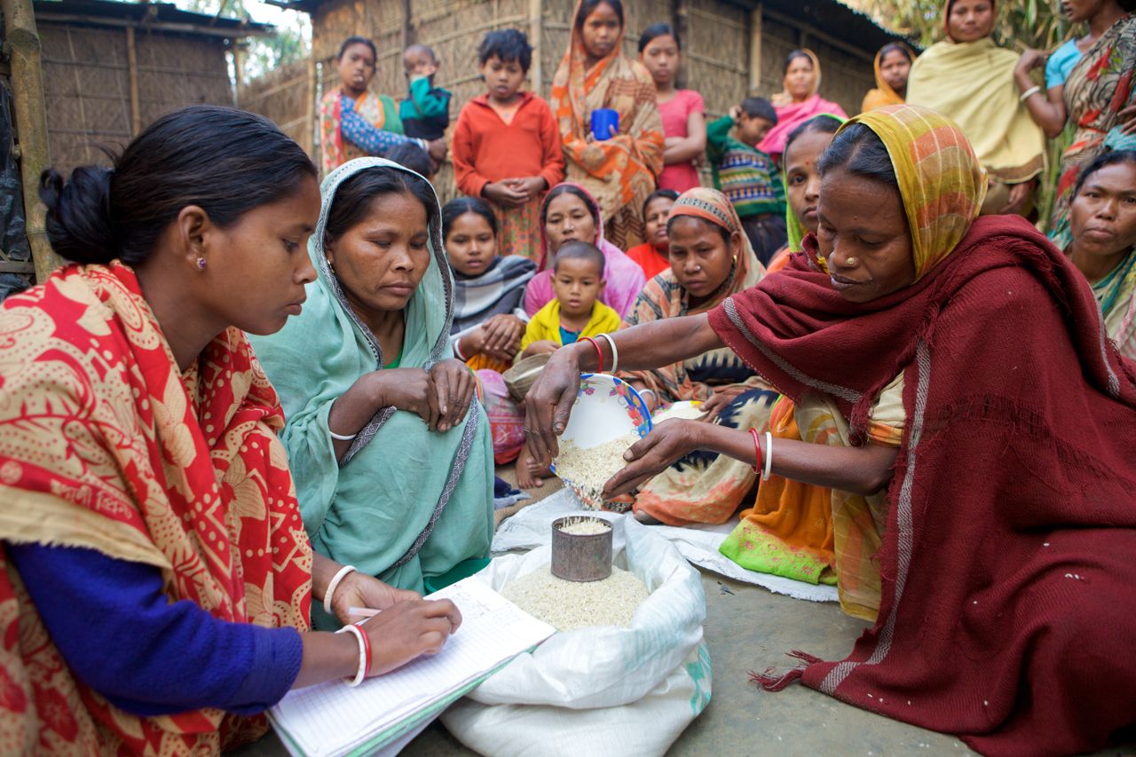 gallery-4 Village women in Bangladesh gather for community development planning and resource distribution.